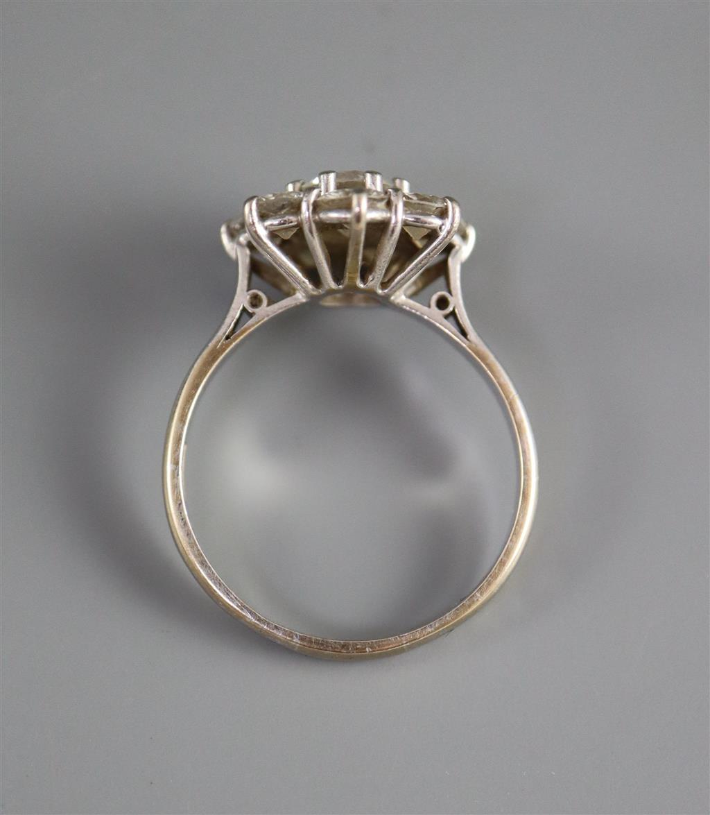 A modern 18ct white gold and eight stone diamond cluster flower head ring,